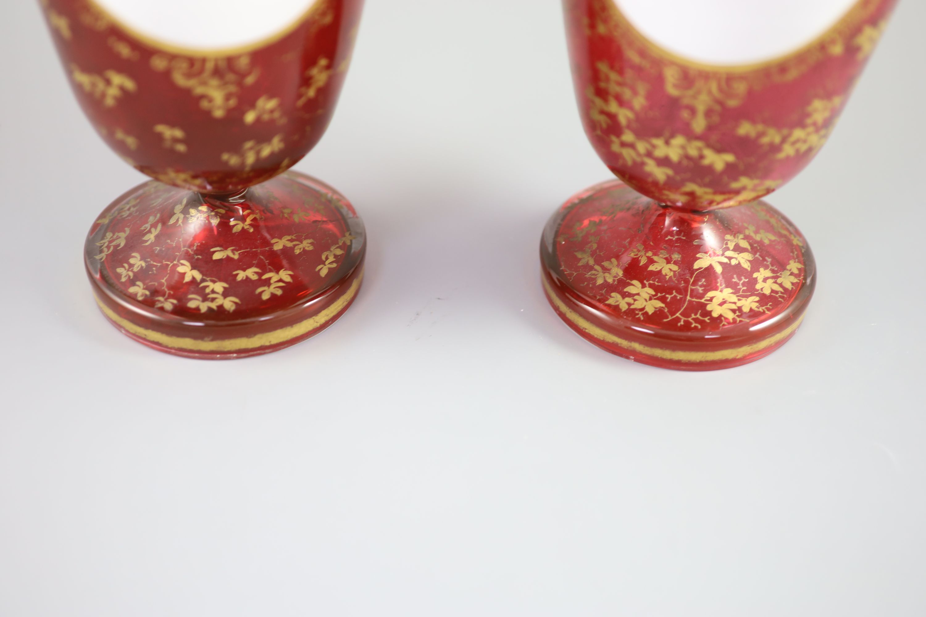 A pair of Bohemian gilt decorated ruby glass two handled vases, late 19th century, height 32cm